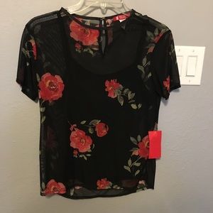 A see through shirt with a cami underneath